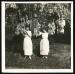 Etta Atwell and Corinne Williams posing in foliage