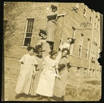 Group of seven students in front of utility pole by Mary Agnes Anderson