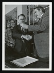 Mississippi Governor William Waller presenting pen to President Hogarth after signing document changing MSCW to MUW